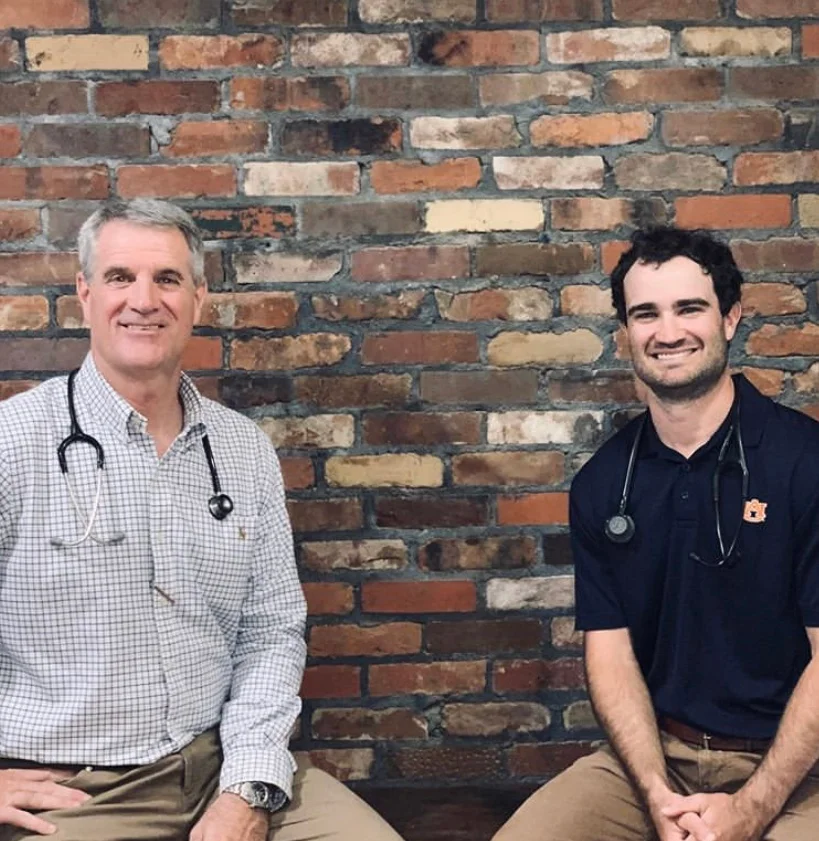 Dr. Robert Hawkins and Dr. Douglas Hawkins, veterinarians at Troy Animal Clinic, standing together at the clinic
